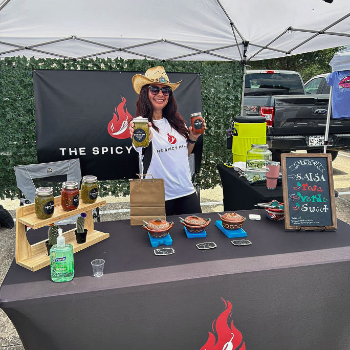 The Spicy palate set up at a local farmers market ready to sell fresh homemade salsas !